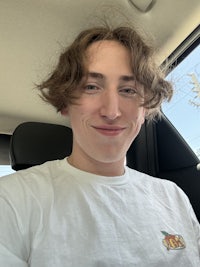 a young man sitting in the back seat of a car